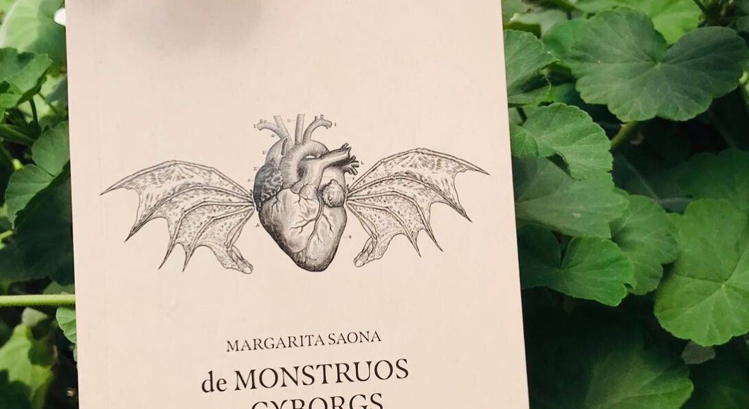 Photo of book in flower bush, heart with wings. De monstrous y cyborgs on cover